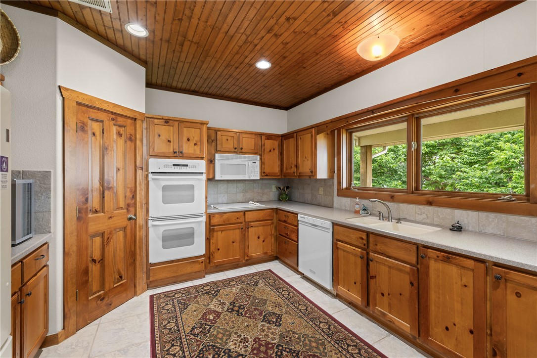 10959 Clyde Acord Road Franklin, TX 77856 - Photo 19 of 44 a large kitchen with stainless steel appliances granite countertop a refrigerator and a sink