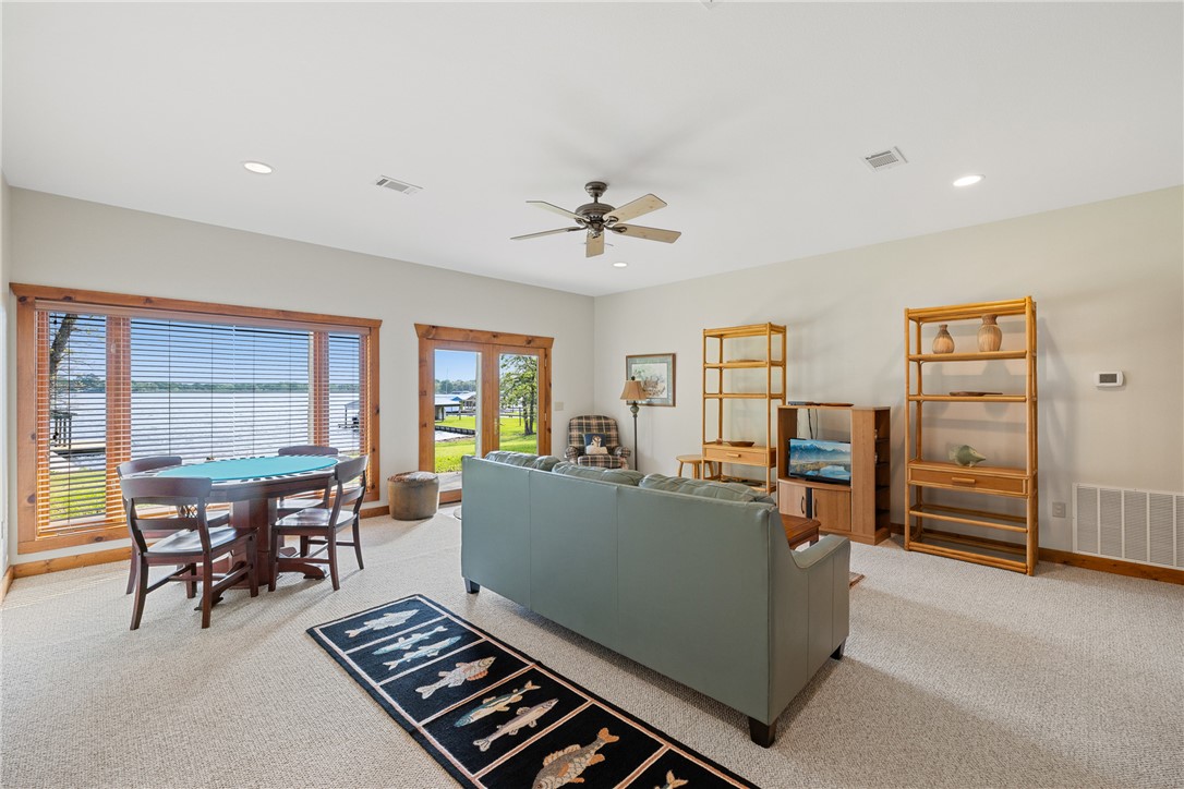 10959 Clyde Acord Road Franklin, TX 77856 - Photo 24 of 44 a living room with furniture gym equipment and large windows