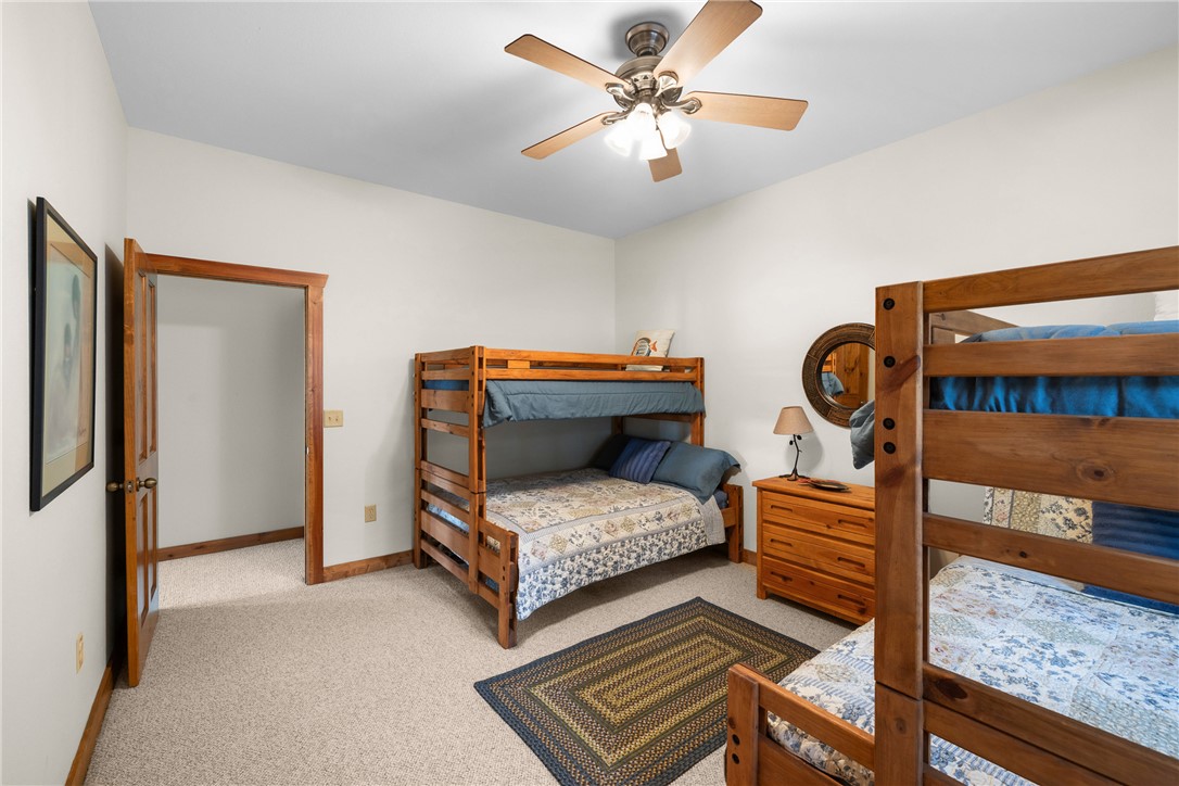 10959 Clyde Acord Road Franklin, TX 77856 - Photo 27 of 44 a bedroom with two beds and a chandelier