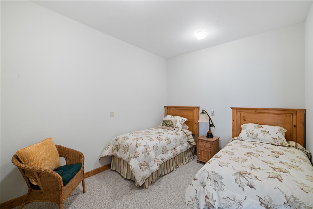 10959 Clyde Acord Road Franklin, TX 77856 - Photo 28 of 44 a bedroom with two beds and a chair