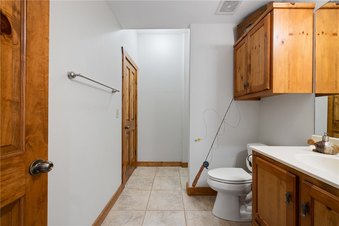 10959 Clyde Acord Road Franklin, TX 77856 - Photo 29 of 44 a bathroom with a granite countertop sink toilet and shower