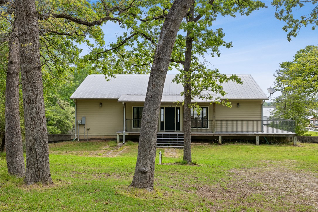 10959 Clyde Acord Road Franklin, TX 77856 - Photo 43 of 44 a front view of a house with a yard