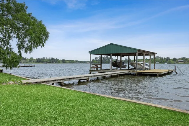 a backyard of a house with lots of green space and fountain