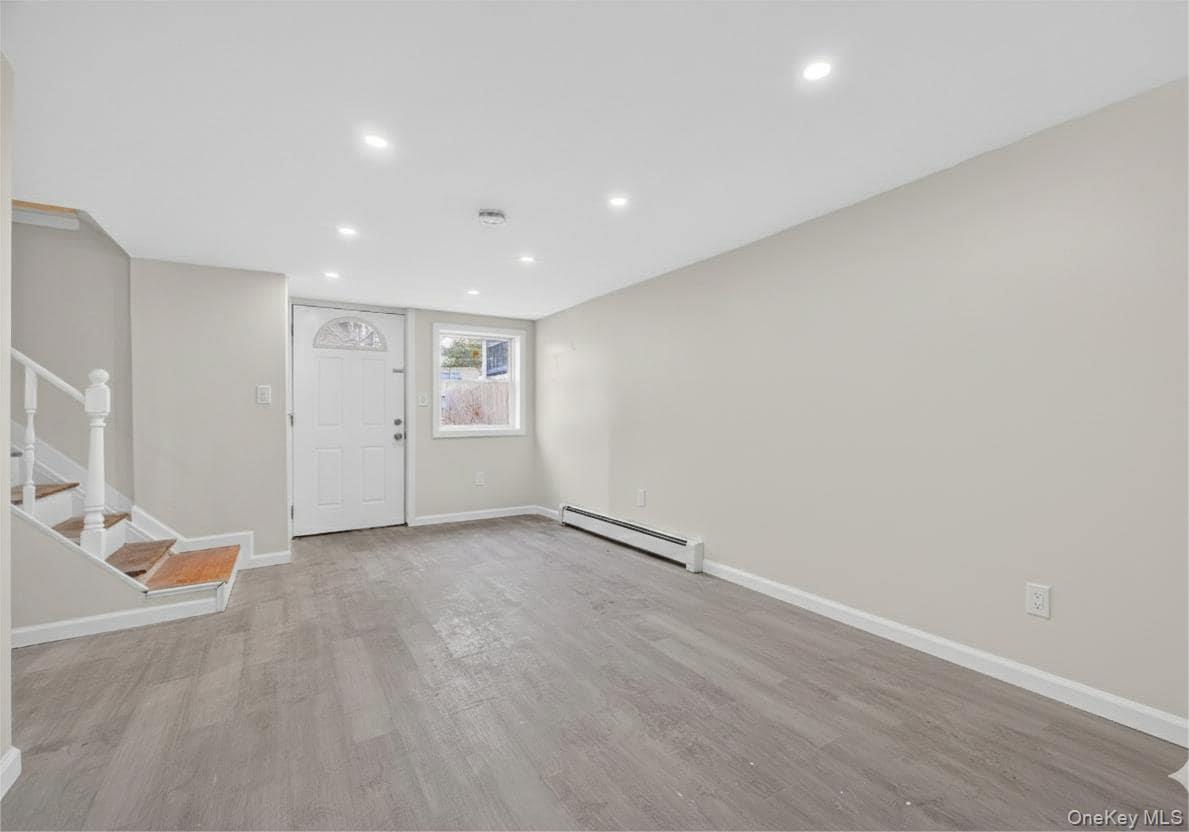 149 Lewis Lane, Unit 3 Wallkill, NY 12589 - Photo 4 of 11 wooden floor in an empty room with a window
