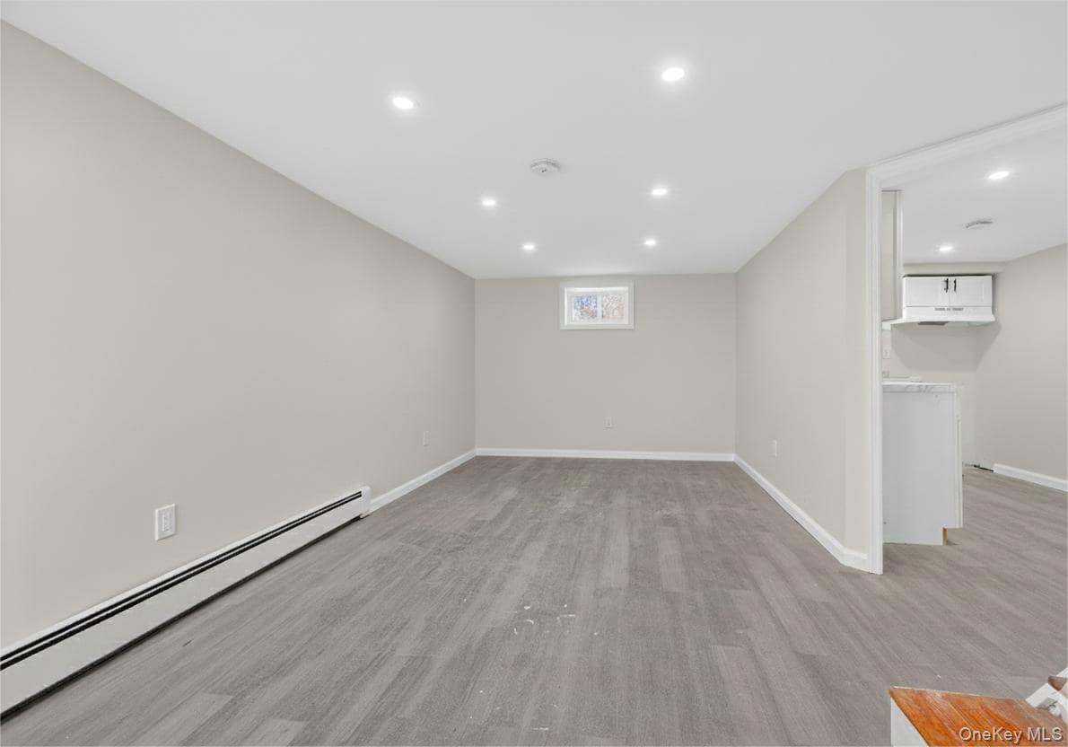 149 Lewis Lane, Unit 3 Wallkill, NY 12589 - Photo 6 of 11 an empty room with wooden floor and windows