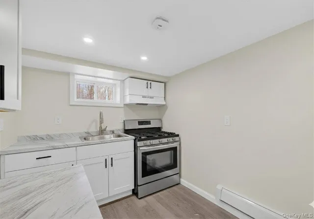 a kitchen with appliances cabinets and a sink