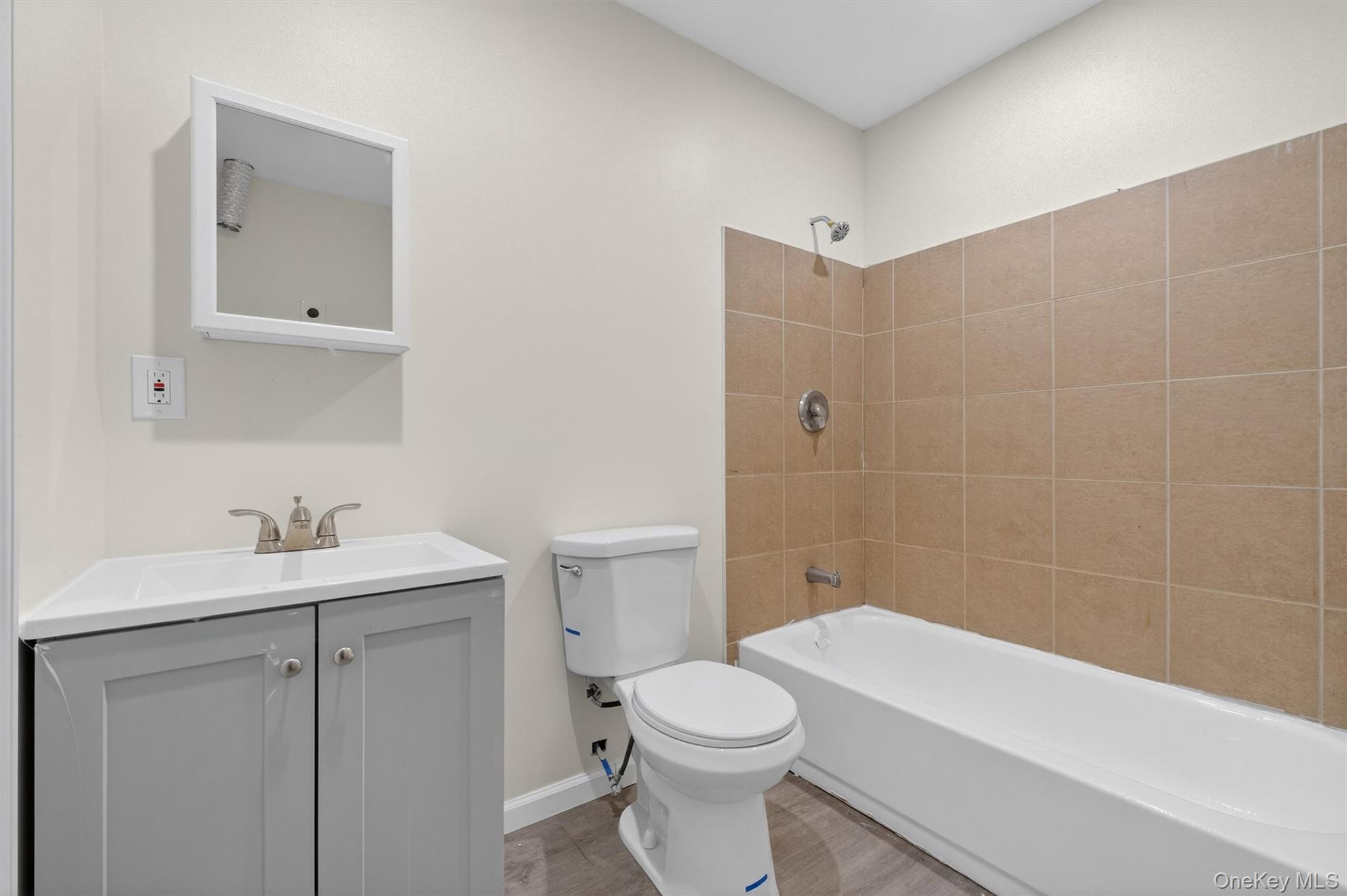 149 Lewis Lane, Unit 3 Wallkill, NY 12589 - Photo 9 of 11 a bathroom with a sink a toilet and shower