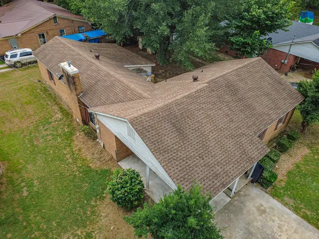 an aerial view of multiple houses with yard