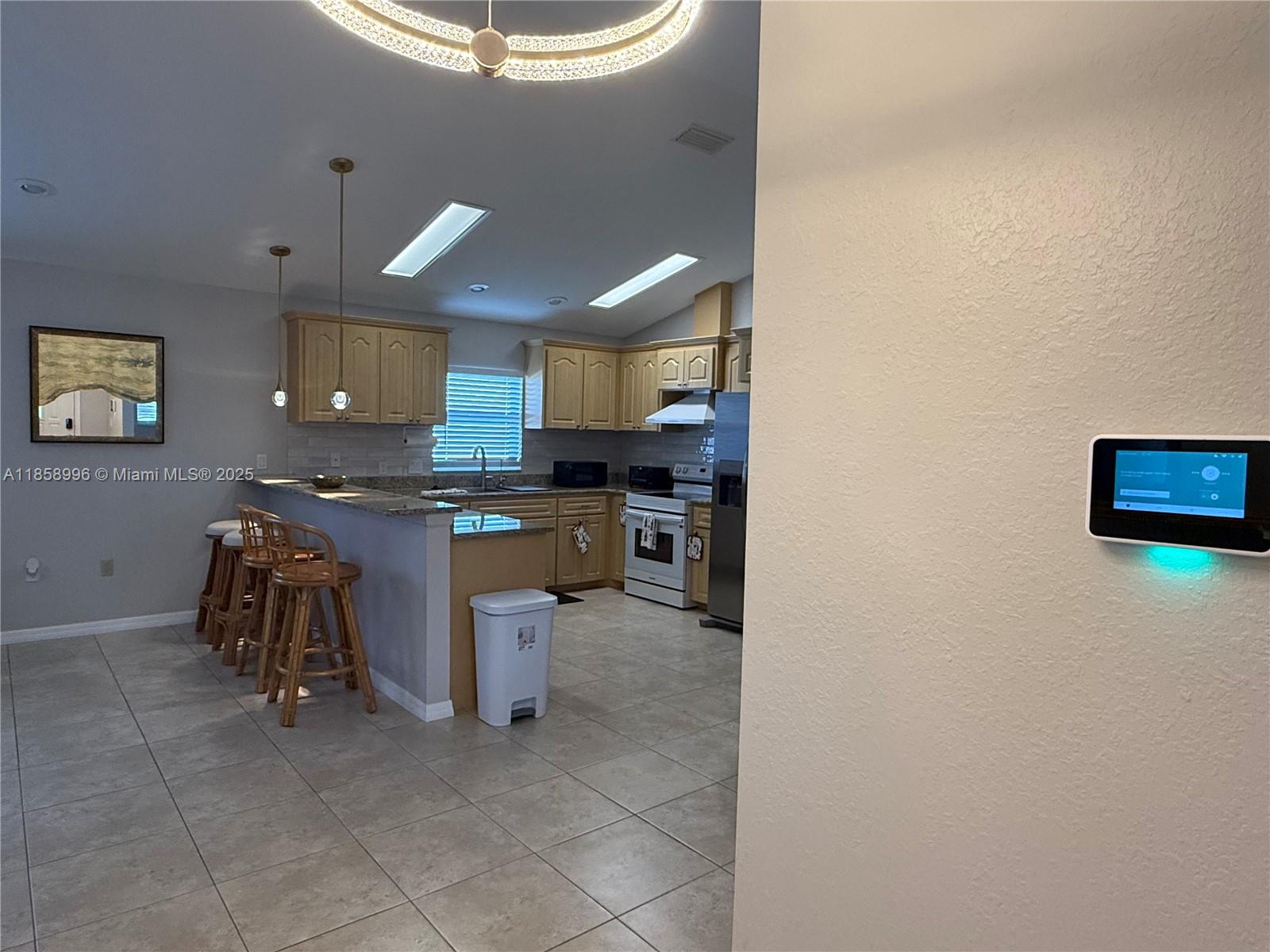 4115 Hammock Road Sebring, FL 33875 - Photo 11 of 25 a kitchen with stainless steel appliances granite countertop a sink and cabinets
