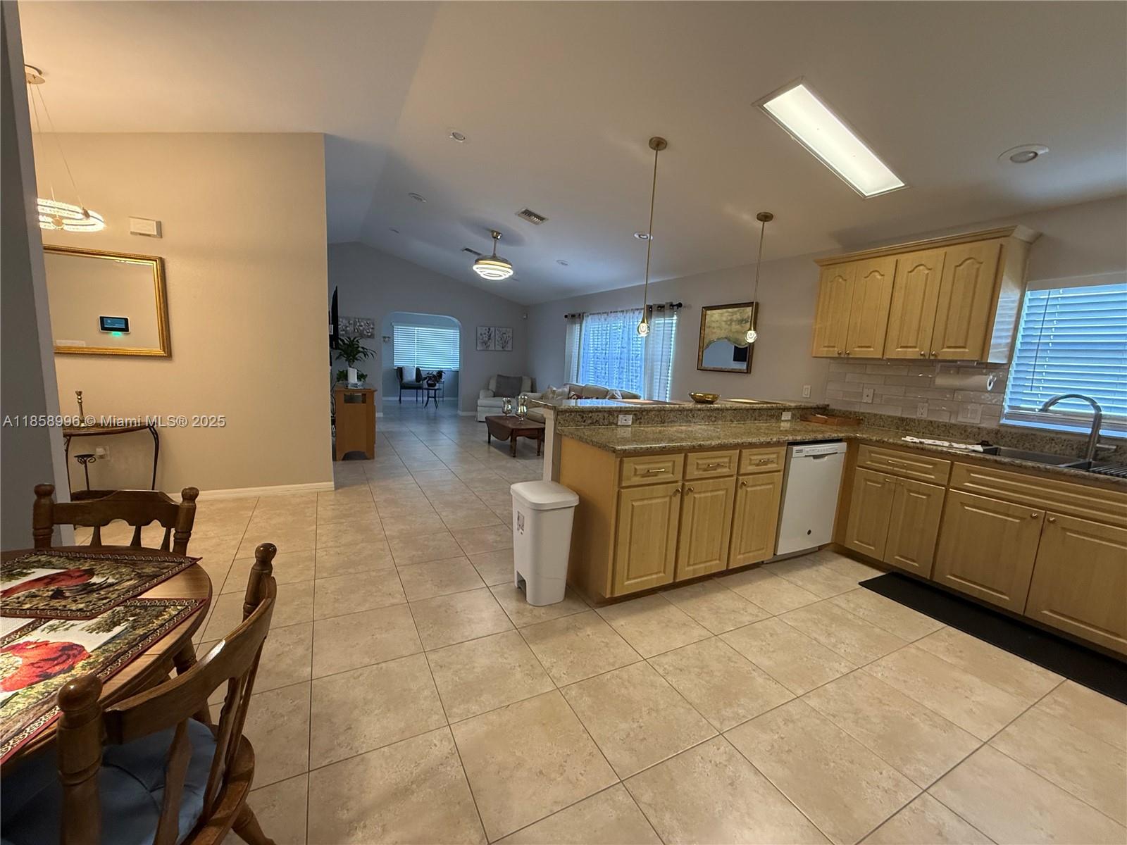 4115 Hammock Road Sebring, FL 33875 - Photo 12 of 25 a kitchen with a stove sink cabinets and wooden floor