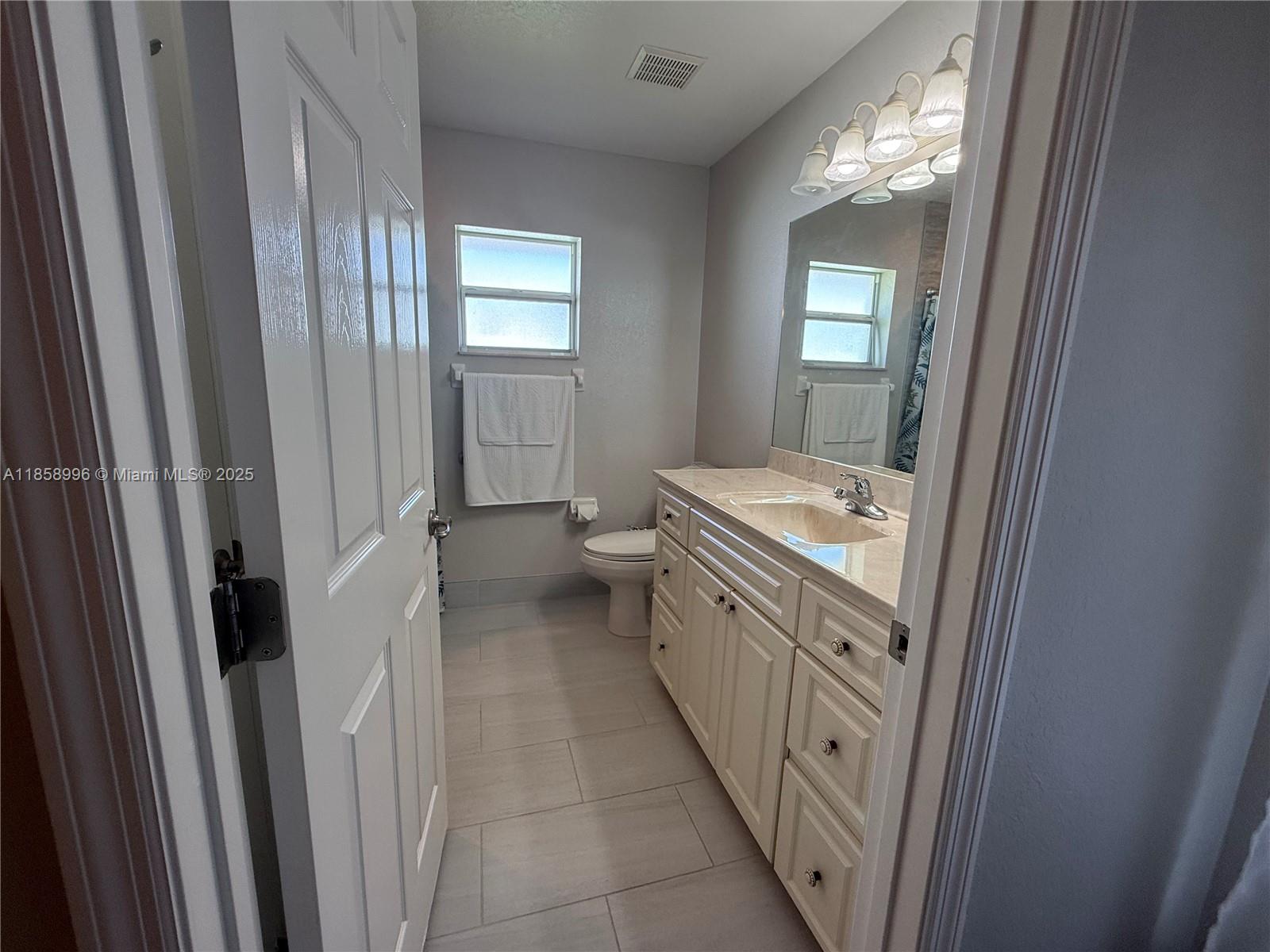 4115 Hammock Road Sebring, FL 33875 - Photo 18 of 25 a bathroom with a sink a toilet and mirror