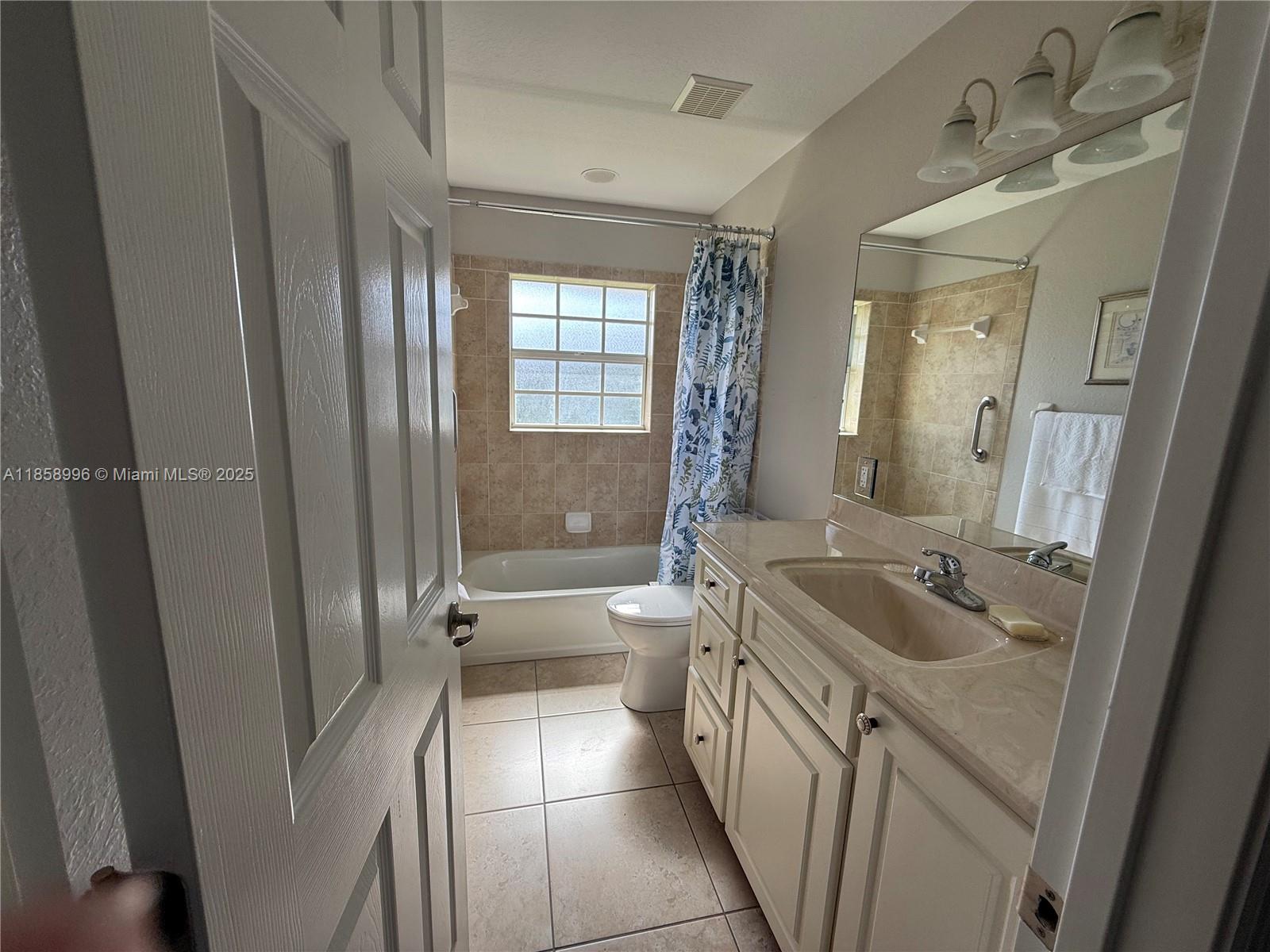4115 Hammock Road Sebring, FL 33875 - Photo 22 of 25 a spacious bathroom with a granite countertop sink a toilet a mirror and shower