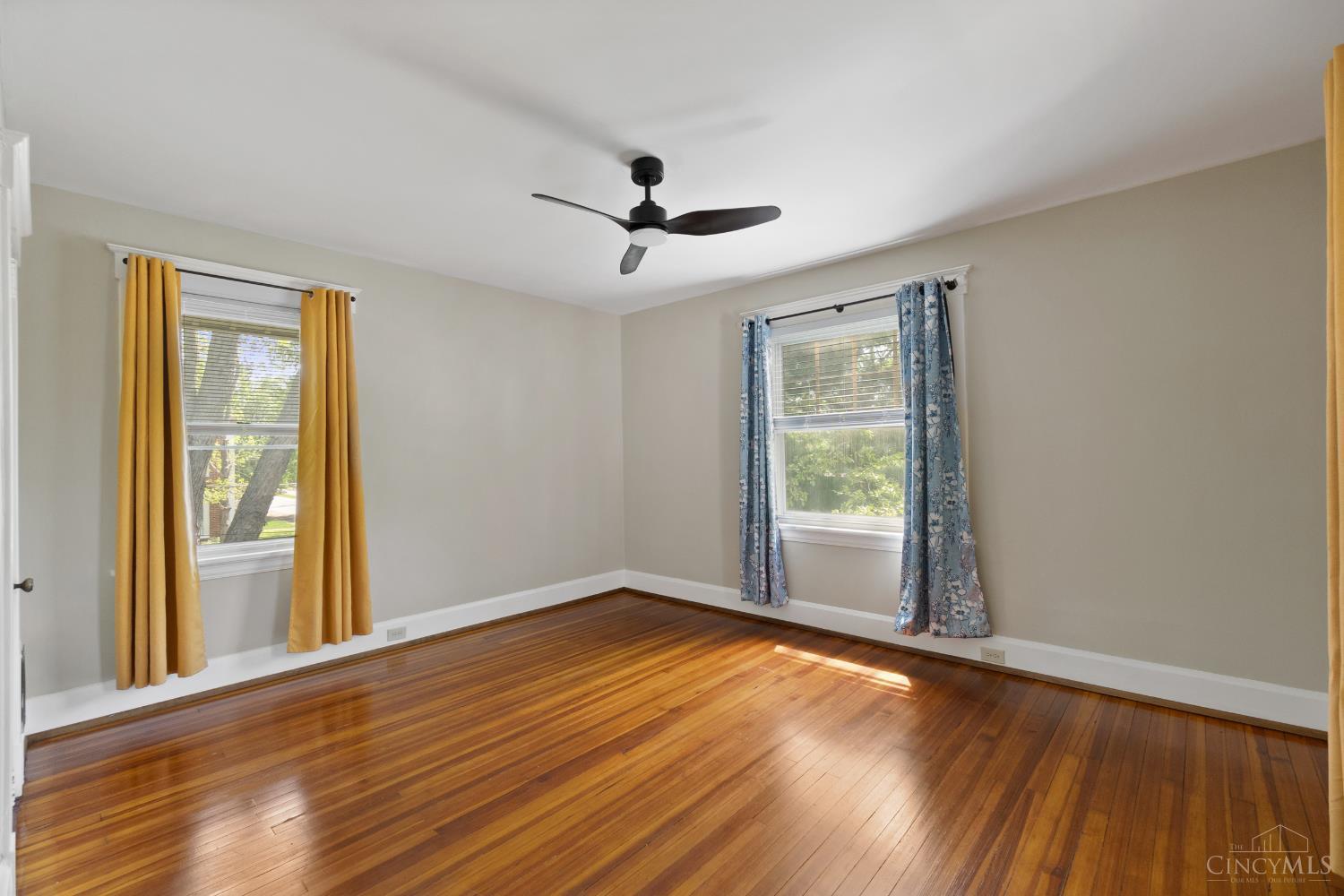 6606 Murray Road Cincinnati, OH 45227 - Photo 16 of 29 Primary bedroom with hardwood floors and newer light fixture/ceiling fan.