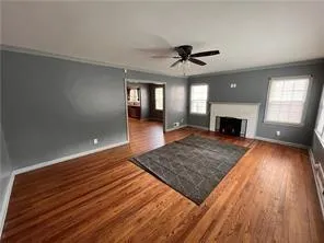 a view of a room wooden floor and ceiling fan