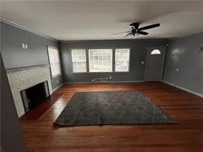a view of a livingroom with a fireplace and window