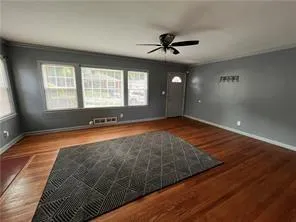 a view of a livingroom with a ceiling fan and window