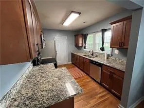 a bathroom with a granite countertop sink and a large mirror