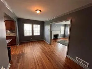 wooden floor in an empty room with a window