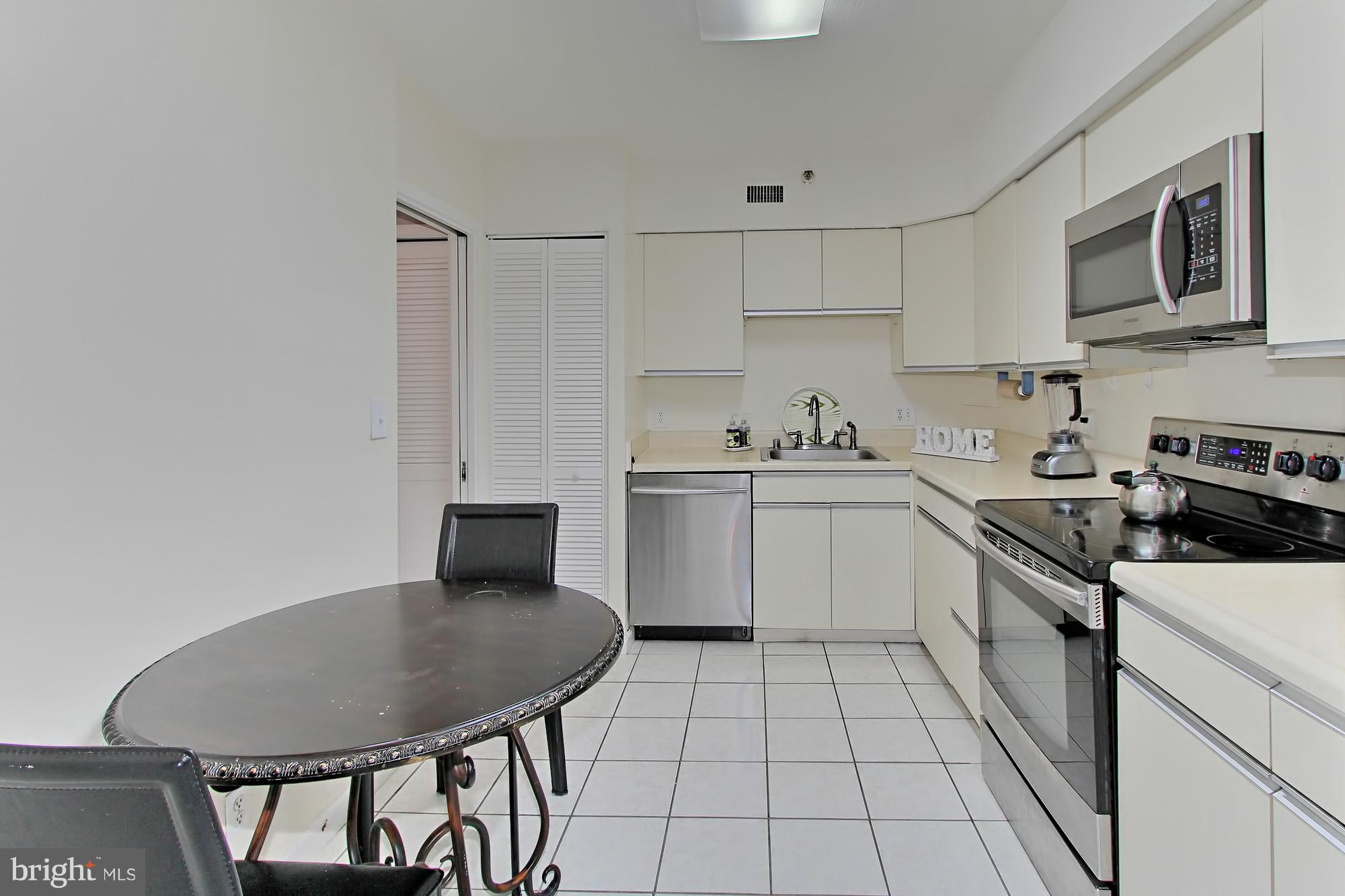 5501 Seminary Road, Unit 314S Falls Church, VA 22041 - Photo 3 of 30 a kitchen with a sink a stove and chairs