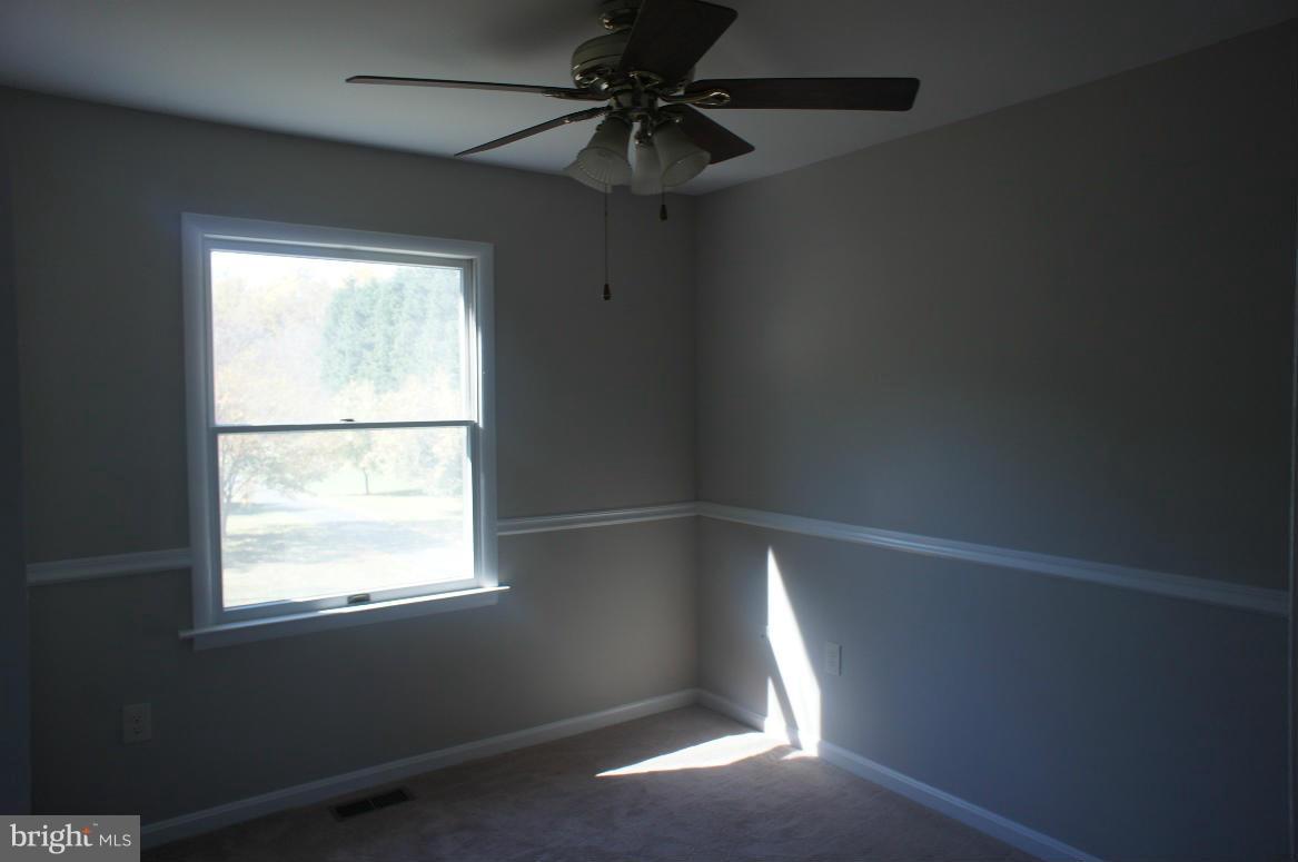 3042 Soper Road Huntingtown, MD 20639 - Photo 3 of 15 a view of an empty room with a window