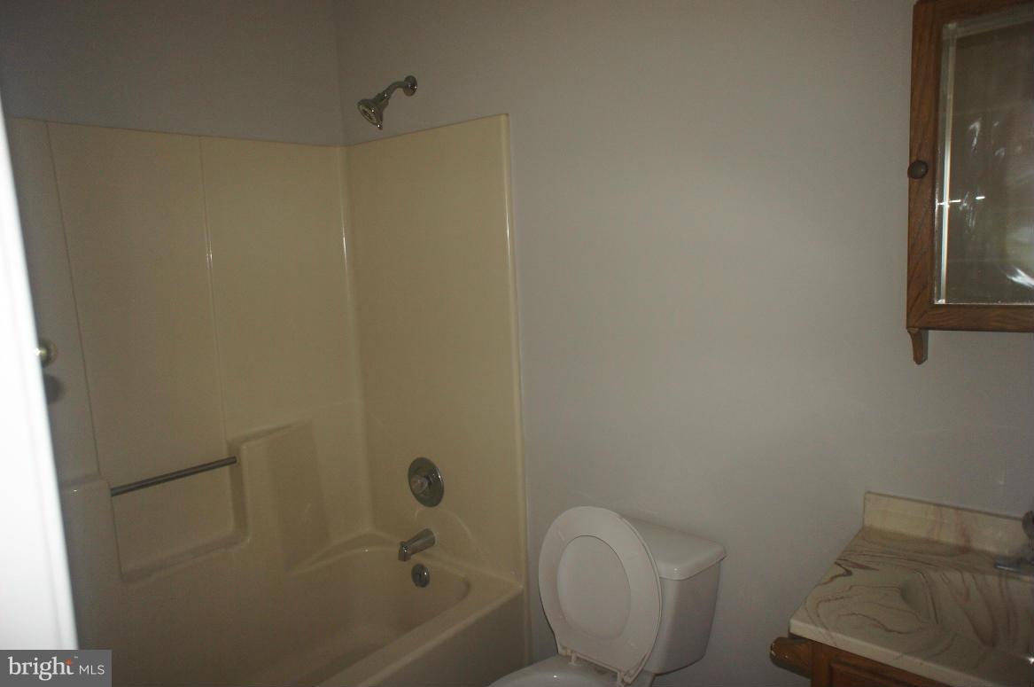 3042 Soper Road Huntingtown, MD 20639 - Photo 10 of 15 a bathroom with a toilet and bathtub