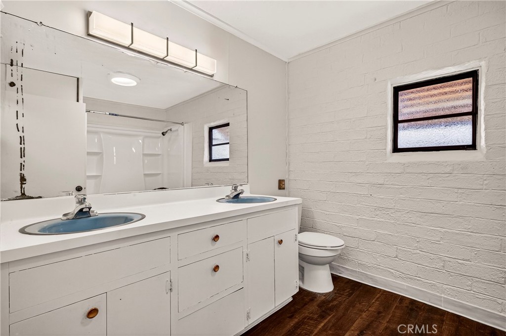 351 2nd Street Hamilton City, CA 95951 - Photo 24 of 52 a bathroom with a double vanity sink toilet and mirror