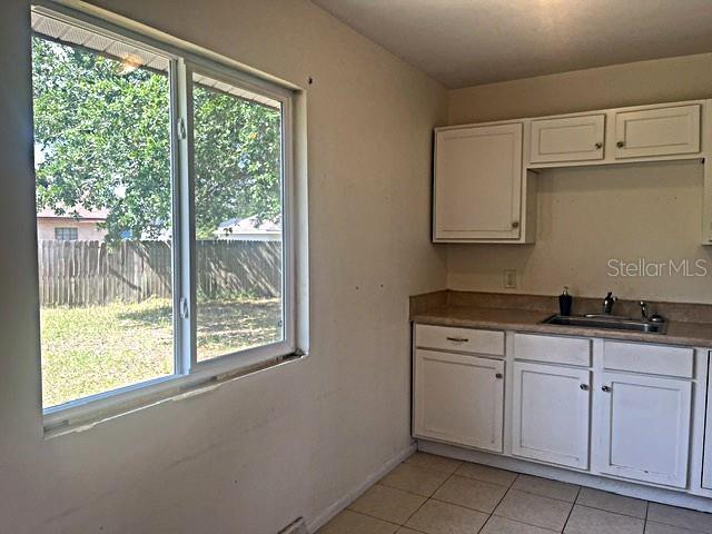 12 Pine Course Way Ocala, FL 34472 - Photo 11 of 29 a kitchen with white cabinets and a window
