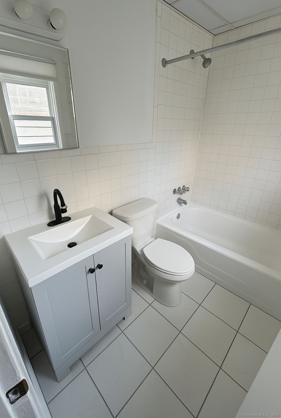 165 McKinley Avenue, Unit 8A Bridgeport, CT 06606 - Photo 3 of 3 a bathroom with a sink a toilet and a bathtub