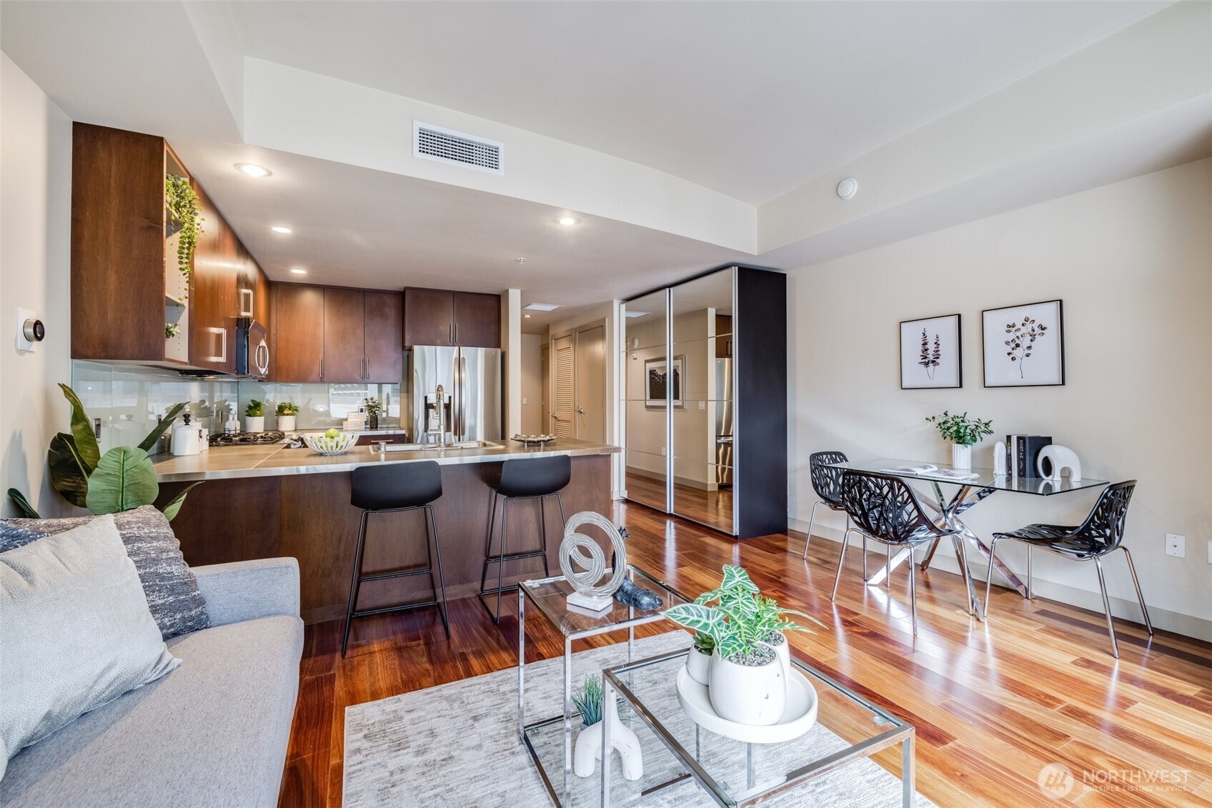 a living room with lots of furniture and kitchen view