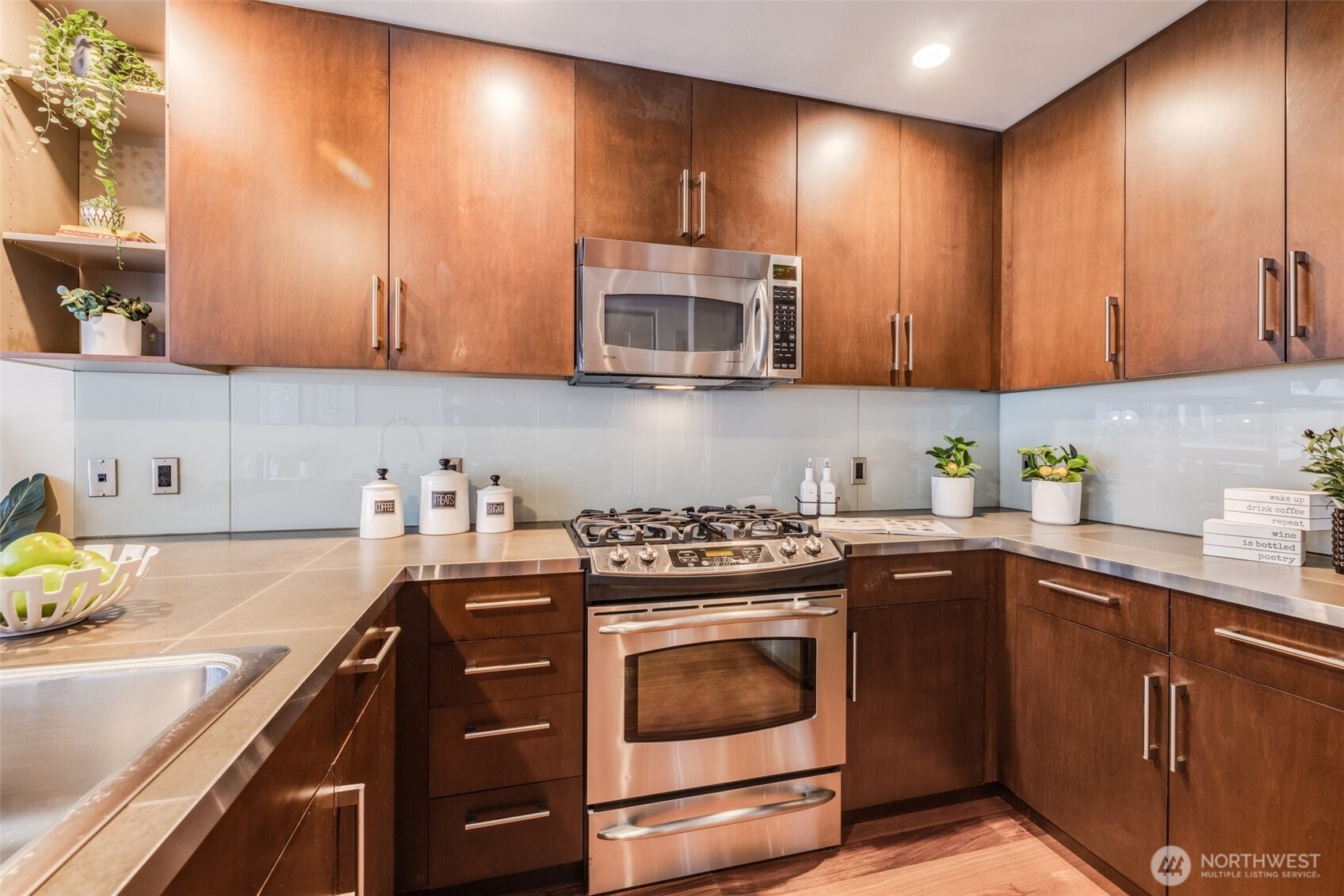 900 Lenora Street, Unit W402 Seattle, WA 98121 - Photo 11 of 39 a kitchen with granite countertop a stove sink and cabinets