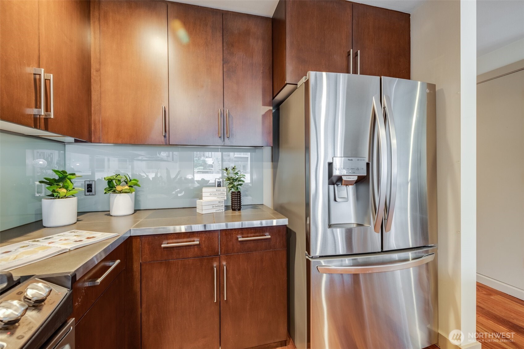 900 Lenora Street, Unit W402 Seattle, WA 98121 - Photo 12 of 39 a kitchen with stainless steel appliances granite countertop a refrigerator and a cabinets