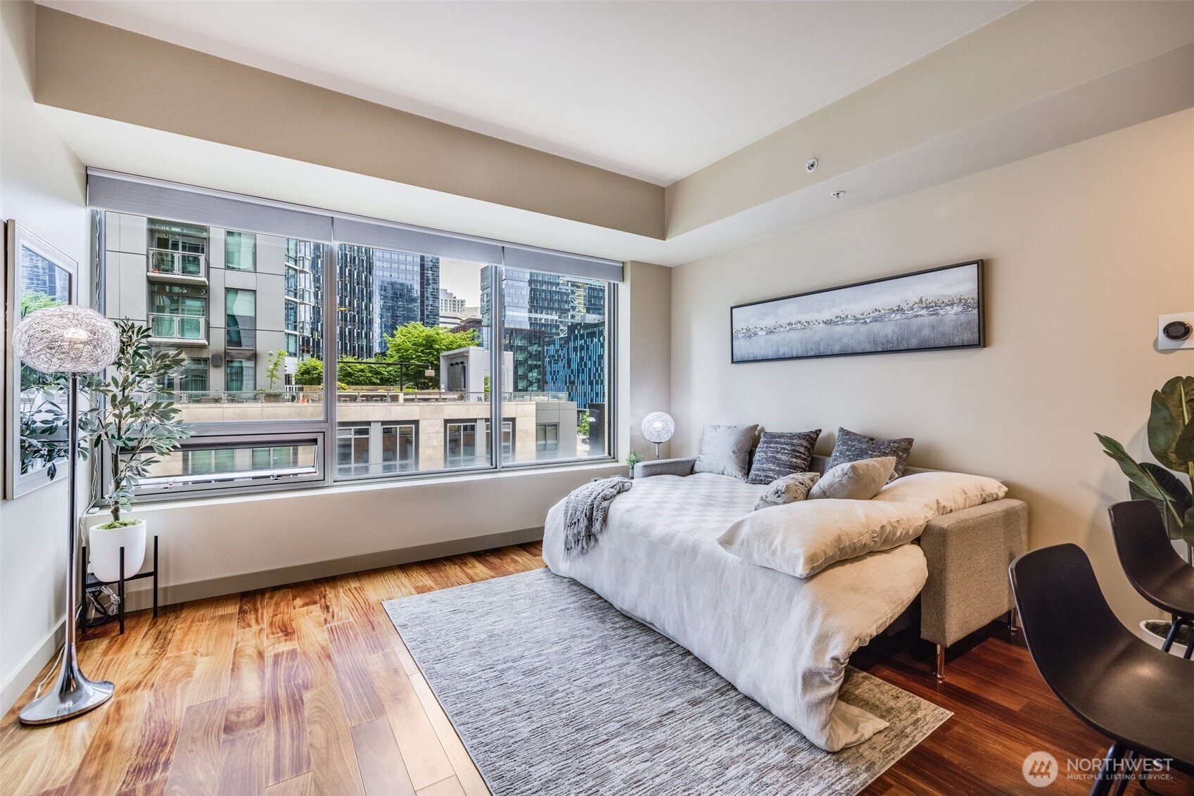900 Lenora Street, Unit W402 Seattle, WA 98121 - Photo 16 of 39 a bedroom with furniture and a large window