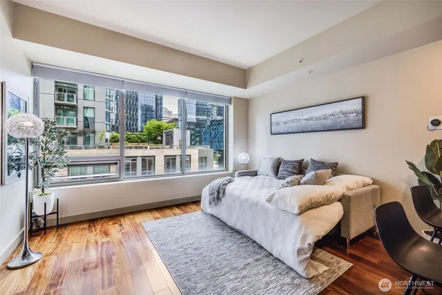 a bedroom with furniture and a large window
