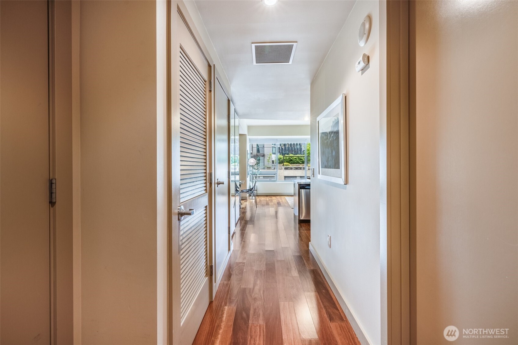 900 Lenora Street, Unit W402 Seattle, WA 98121 - Photo 2 of 39 a view of a hallway with wooden floor and furniture