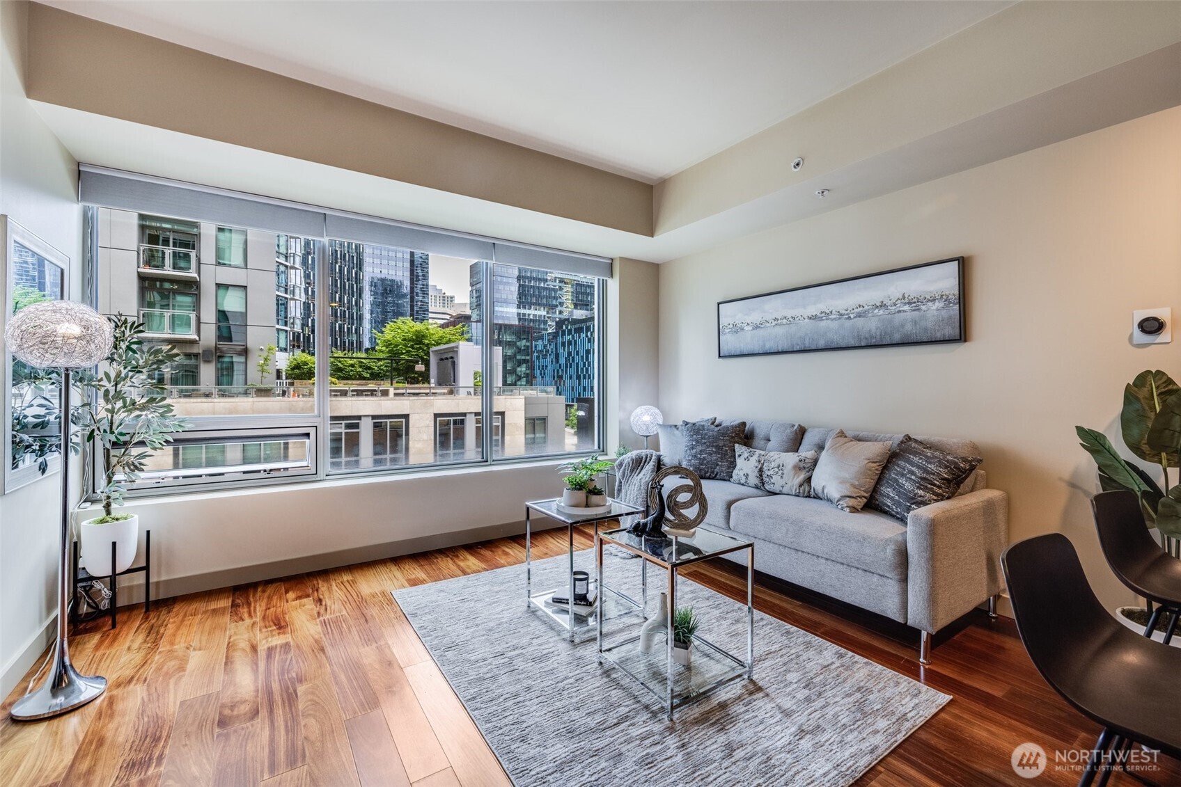 900 Lenora Street, Unit W402 Seattle, WA 98121 - Photo 3 of 39 a living room with furniture and wooden floor
