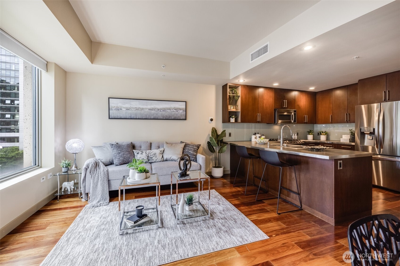 900 Lenora Street, Unit W402 Seattle, WA 98121 - Photo 6 of 39 a living room with stainless steel appliances kitchen island granite countertop furniture wooden floor and a large window