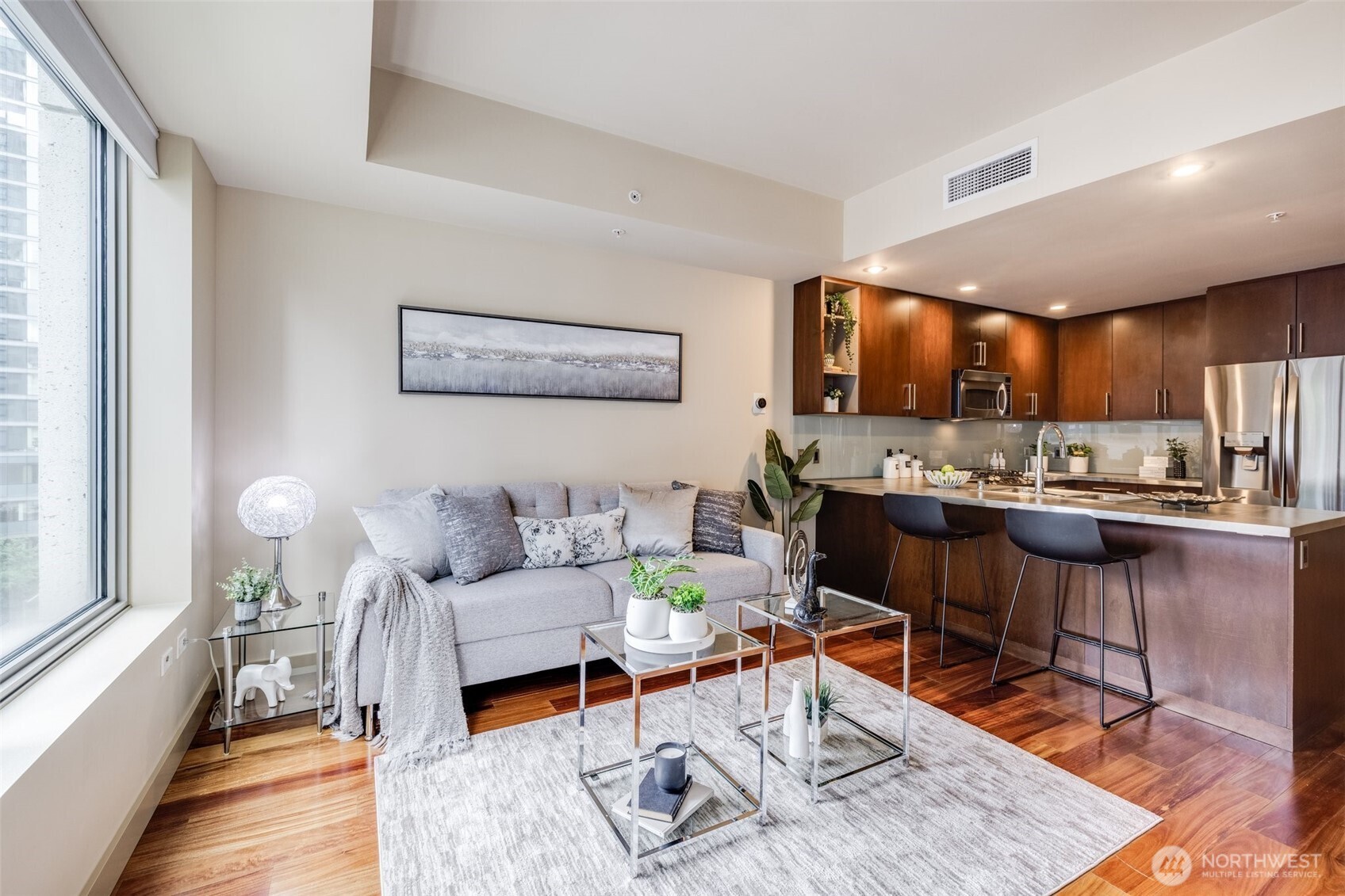 900 Lenora Street, Unit W402 Seattle, WA 98121 - Photo 7 of 39 a living room with furniture and kitchen view