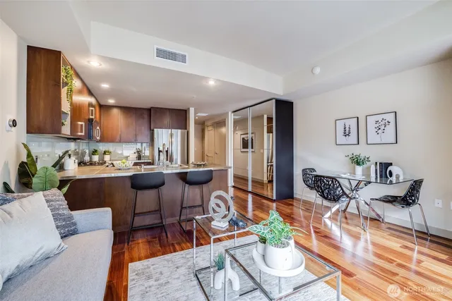 a living room with lots of furniture and kitchen view