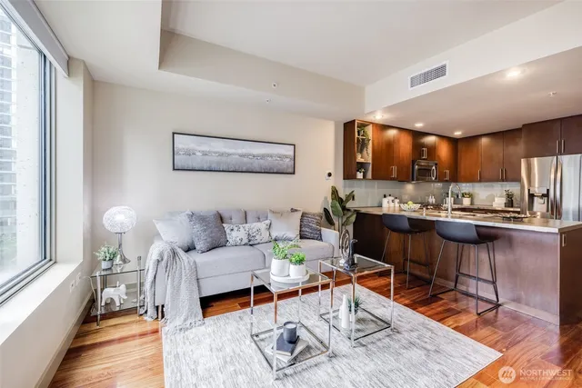 a living room with furniture and kitchen view