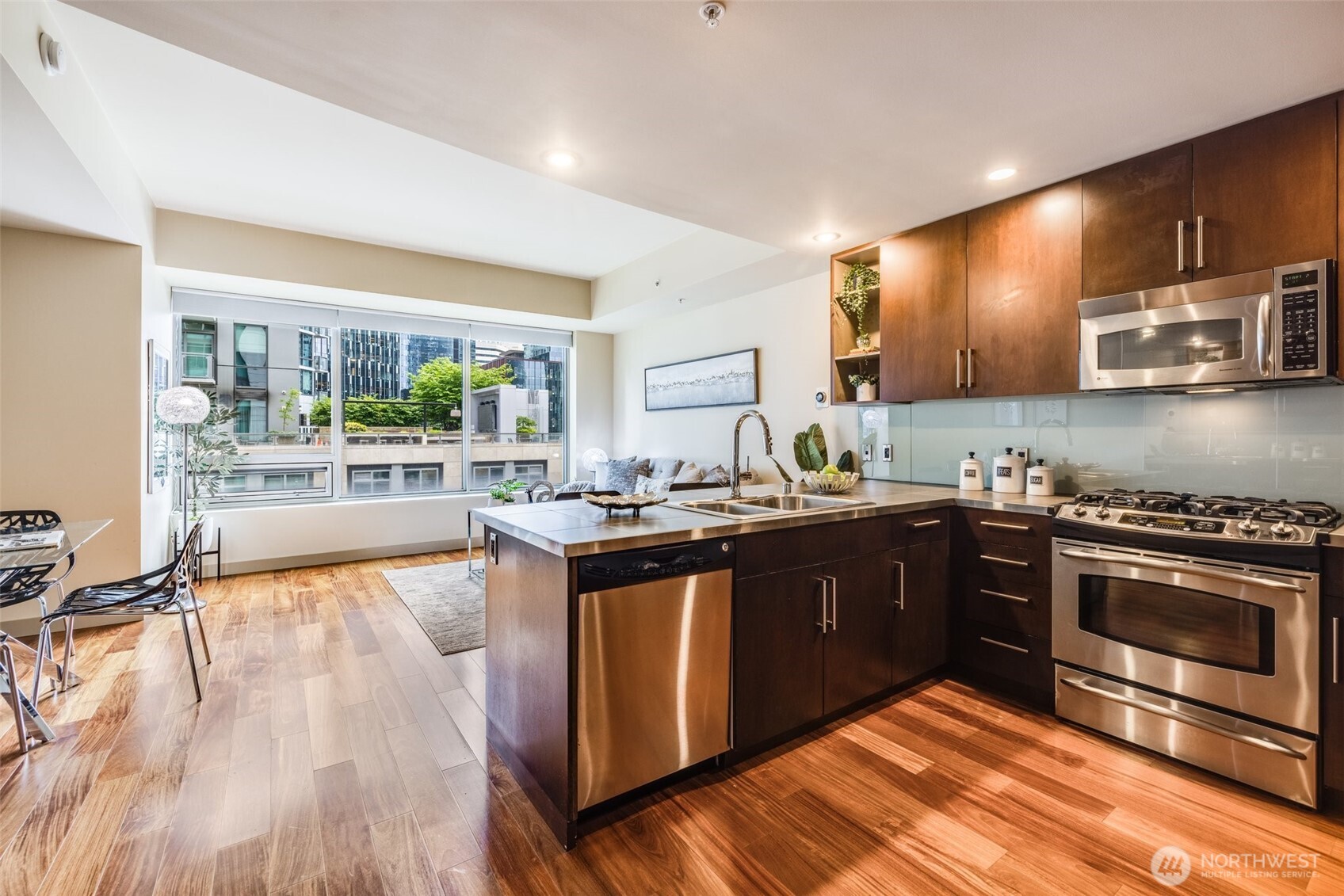 900 Lenora Street, Unit W402 Seattle, WA 98121 - Photo 9 of 39 a kitchen with stainless steel appliances granite countertop a stove a sink and a microwave