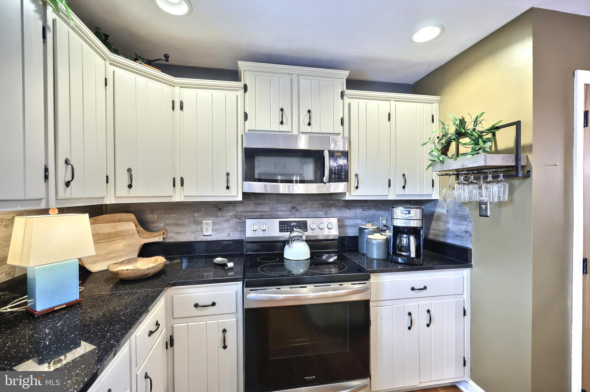 372 Maple Avenue Hanover, PA 17331 - Photo 41 of 87 a kitchen with stainless steel appliances granite countertop a stove a sink and a refrigerator