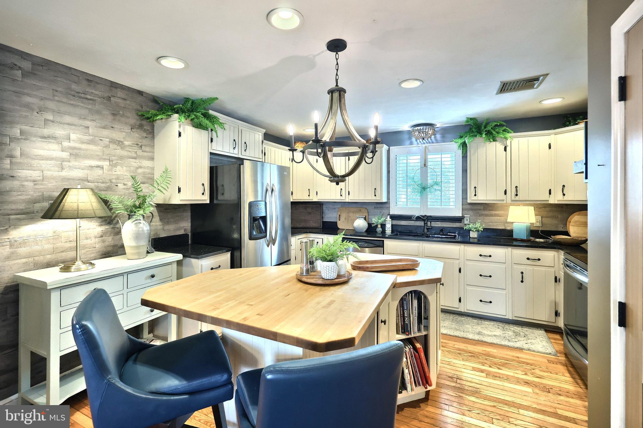 372 Maple Avenue Hanover, PA 17331 - Photo 42 of 87 a kitchen with a dining table chairs wooden floor and appliances