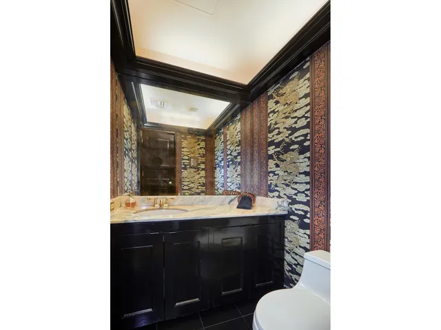 a bedroom with furniture and a large window