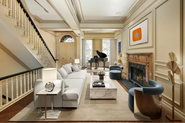 a living room with furniture wooden floor and a fireplace