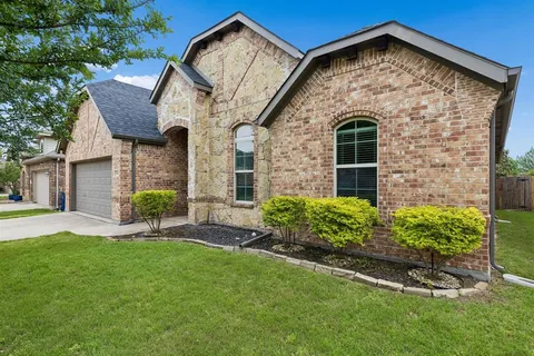 a front view of a house with a yard and porch