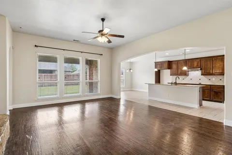 a view of kitchen with granite countertop stainless steel appliances cabinets a sink and a large window