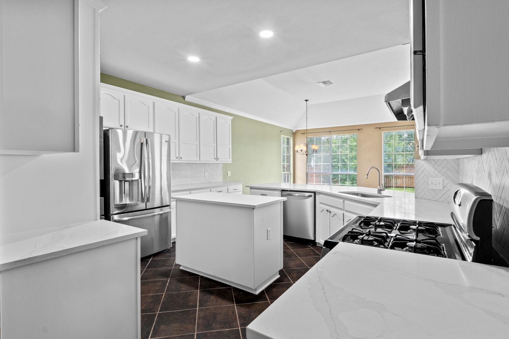 8605 Axis Drive Austin, TX 78749 - Photo 15 of 38 White cabinetry, sleek countertops, and a full suite of stainless steel appliances elevate this well-appointed kitchen.
