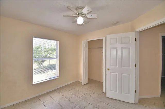a view of an empty room with a fan