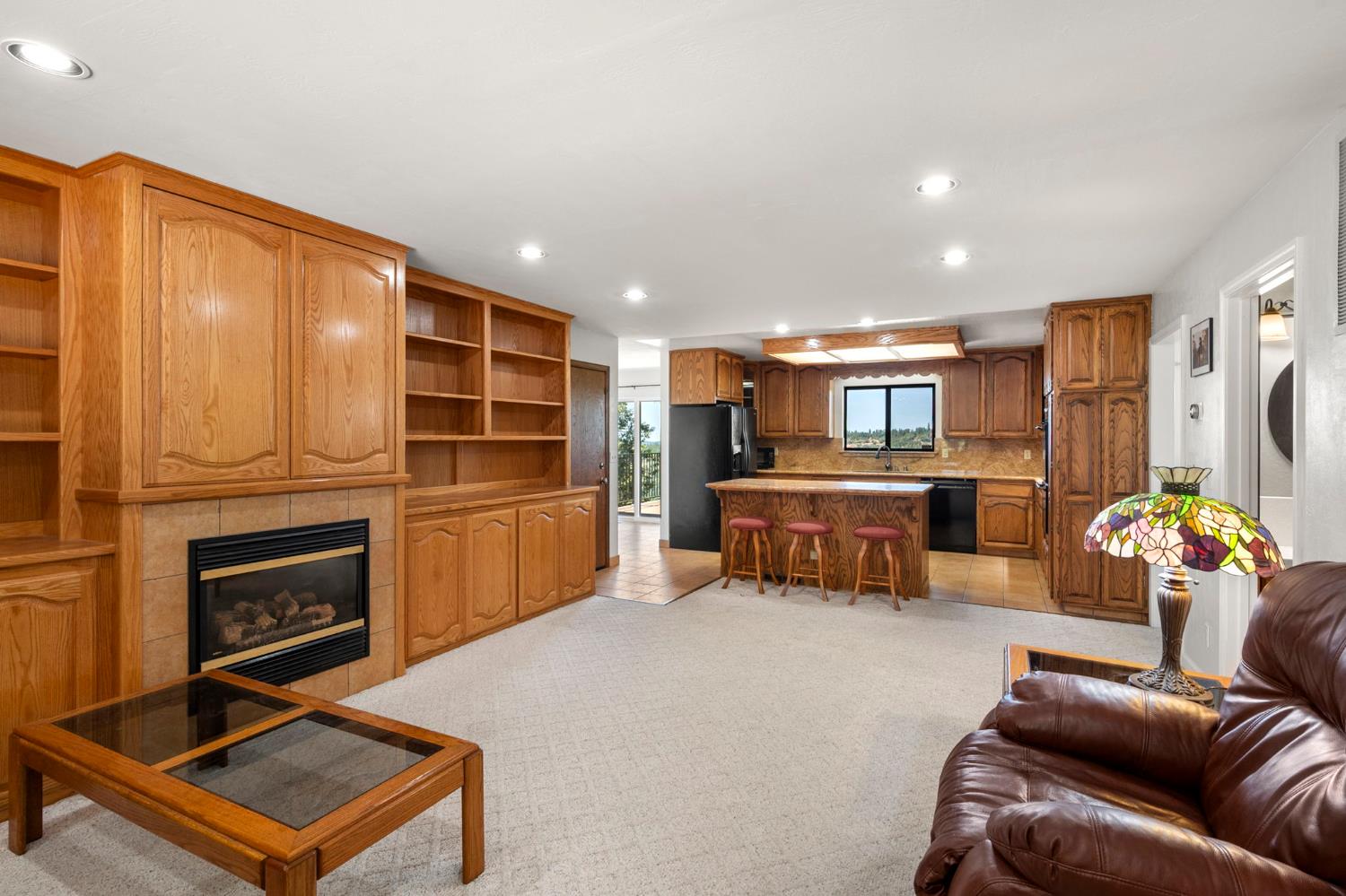 24835 Shake Ridge Road Volcano, CA 95689 - Photo 18 of 79 a living room with furniture kitchen area and a fireplace