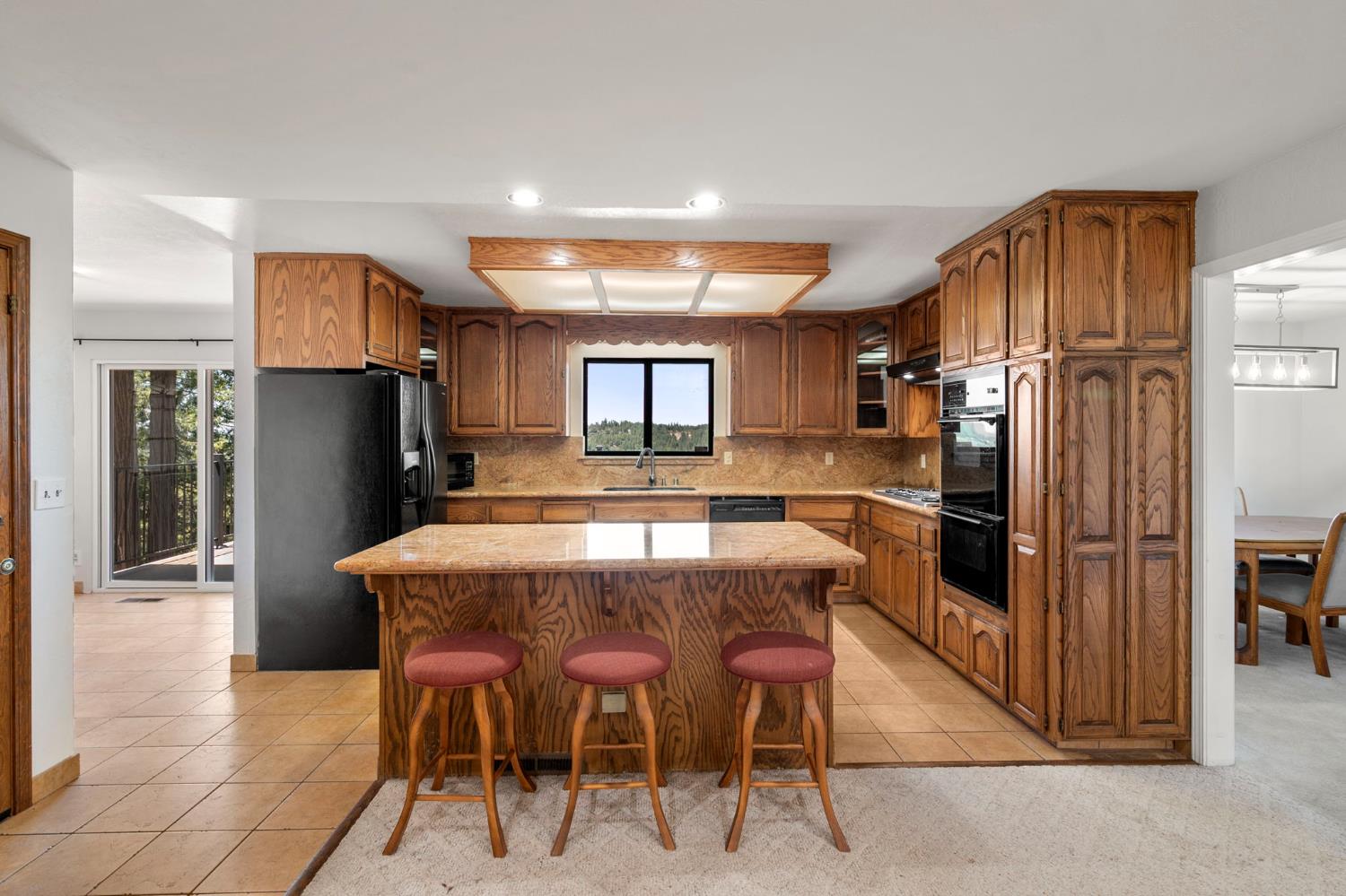 24835 Shake Ridge Road Volcano, CA 95689 - Photo 19 of 79 a kitchen with stainless steel appliances granite countertop a refrigerator and a stove top oven